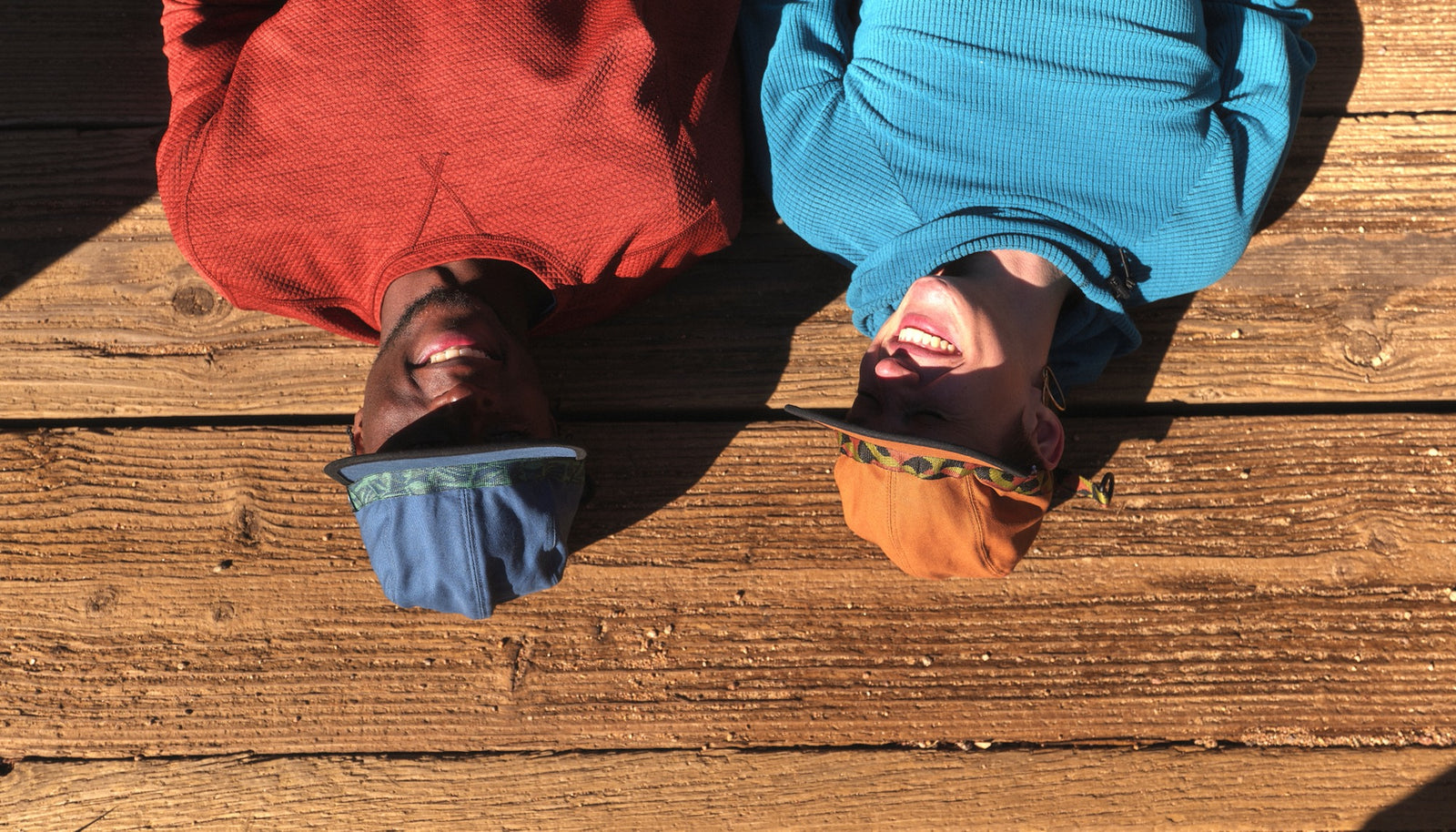 Two people wearing Bedrock X Kavu Hats