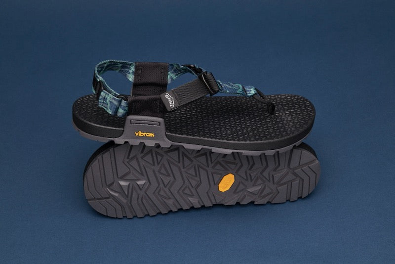 studio photo of a pair of cairn evo 3d pro sandals in blue patterned straps and a blue backdrop