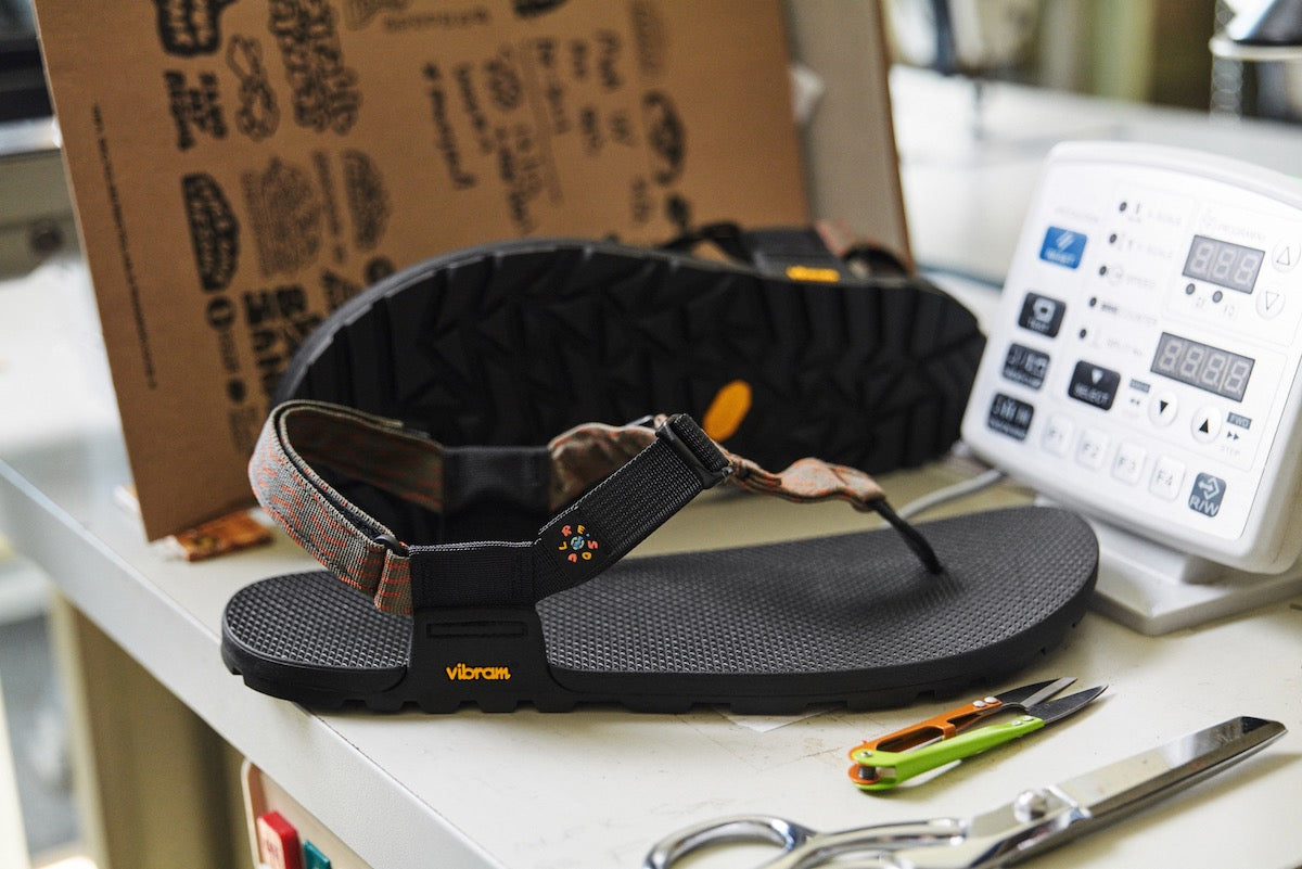 Resouled pair of Cairn Sandals on sewing machine table