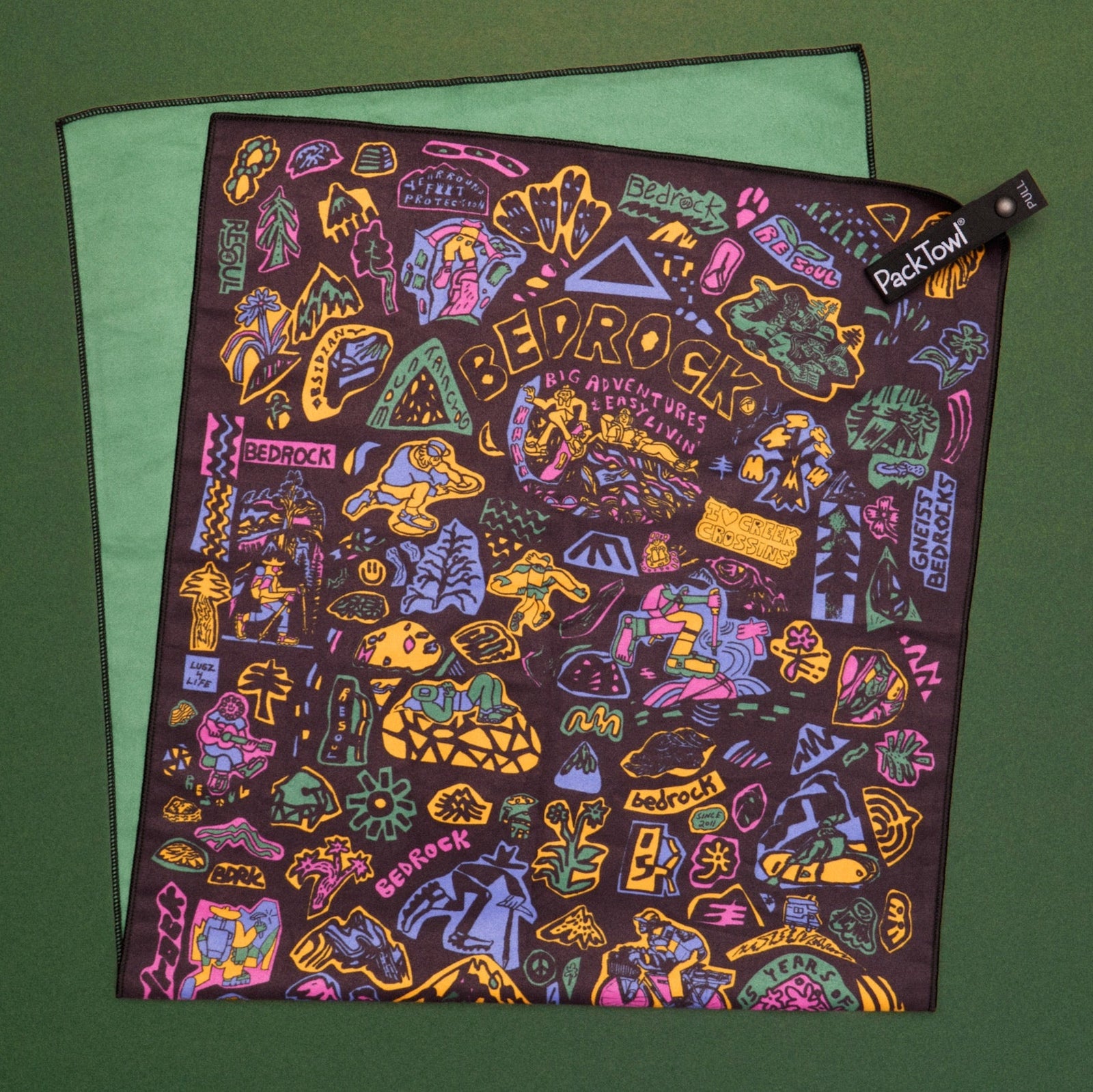 Bedrock Anniversary Pack Towel on a green backdrop