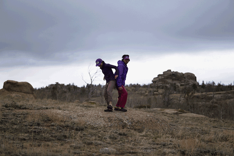 two people running side by side wearing g deep plum leather suede mountain clogs