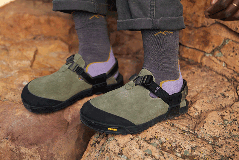 person adjusting pair of sagebrush leather suede mountain clogs