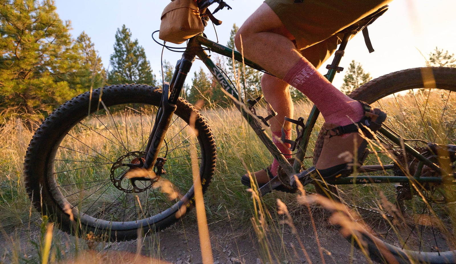 Person riding back wearing Mountain Clogs