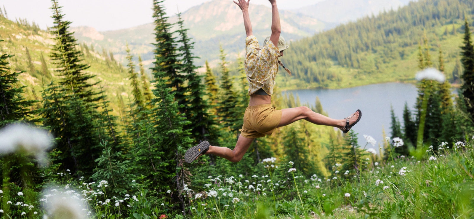 Person Jumping in alpine environment wearing cairn sandals