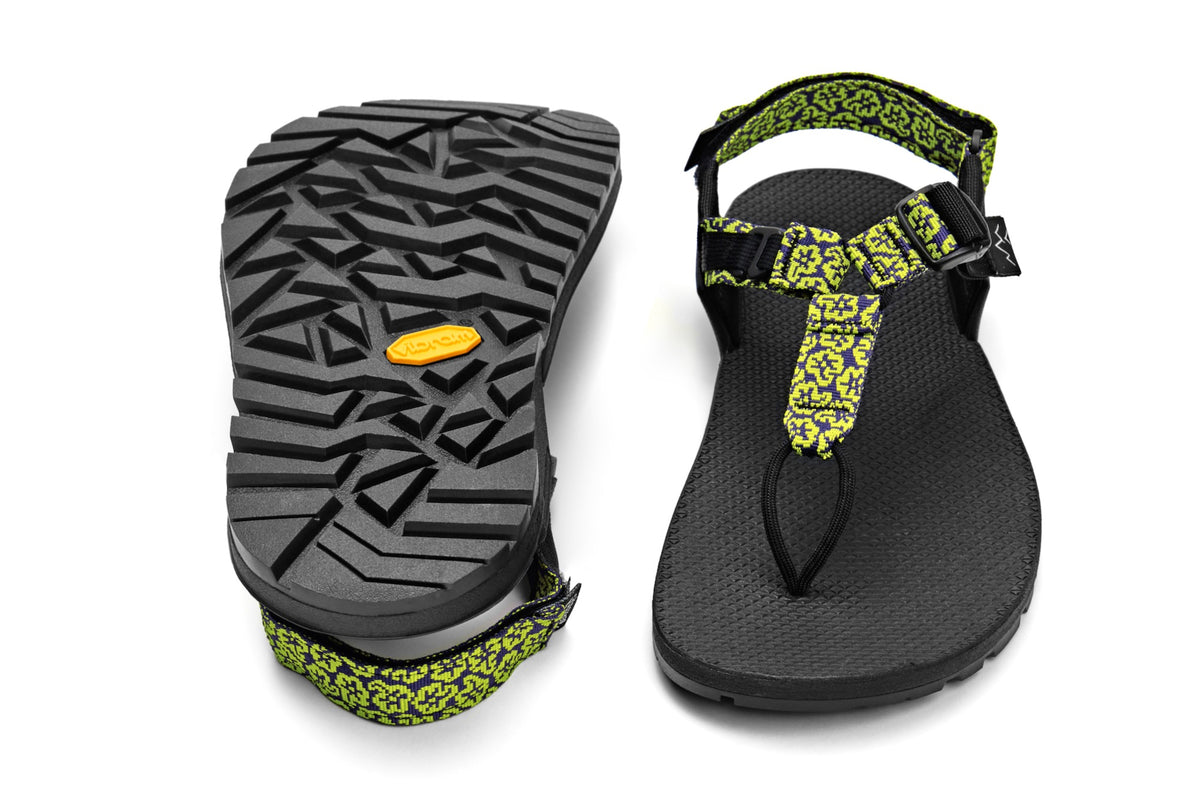 A pair of Cairn Evo Sandals with yellow wildflower pattern straps and rugged Vibram XS Trek Evo sole. 