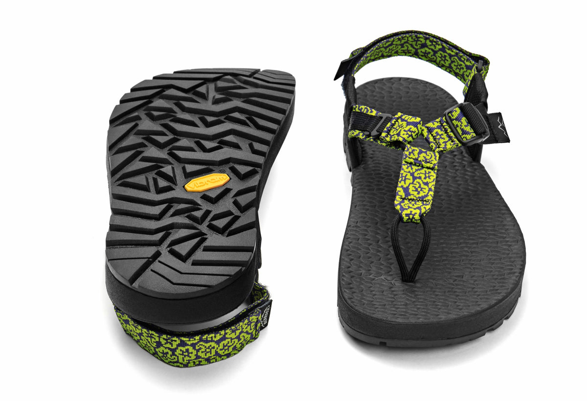 A pair of Cairn Evo C Sandals with yellow wildflower pattern straps and a black rugged sole, including a detailed view of the Vibram XS Trek EVO outsole.