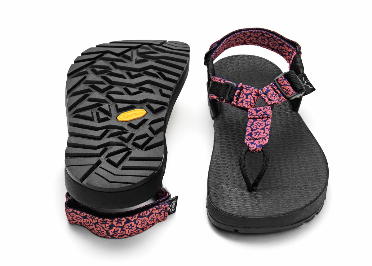 A pair of Cairn Evo C Sandals with pink rose wildflower pattern straps and a black rugged sole, including a detailed view of the Vibram XS Trek EVO outsole.