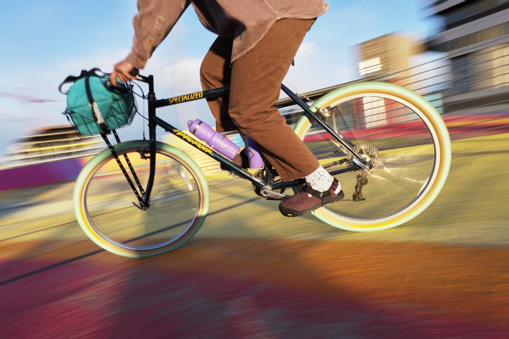 person riding bike wearing deep plum leather suede mountain clogs