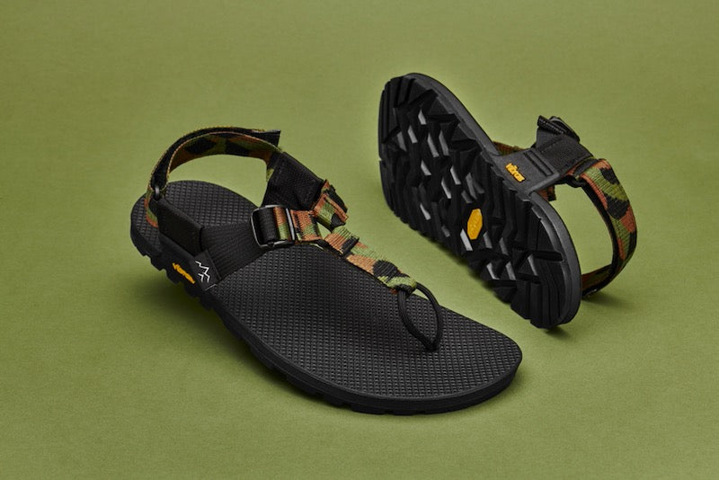 studio photo of cairn evo sandals in block landscape pattern with green background