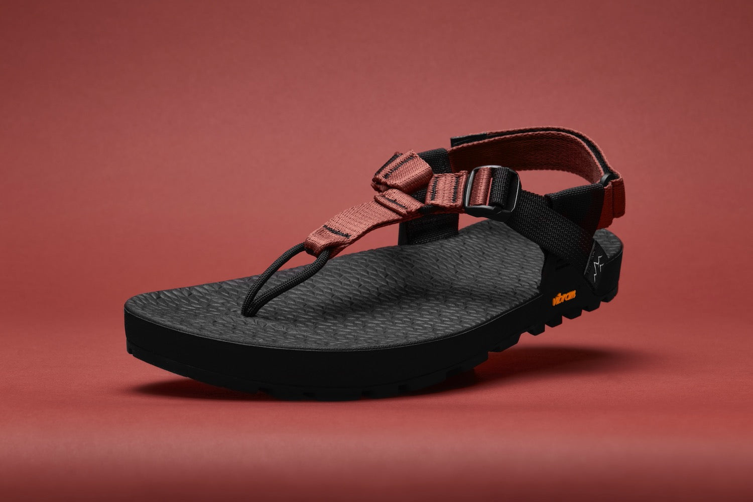 studio photo of lateral view of cairn evo c sandals with clay straps with a clay colored backdrop