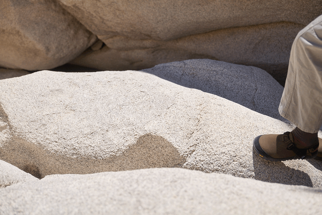 Animated image of someone hiking along white granite rock wearing synthetic mountain clogs