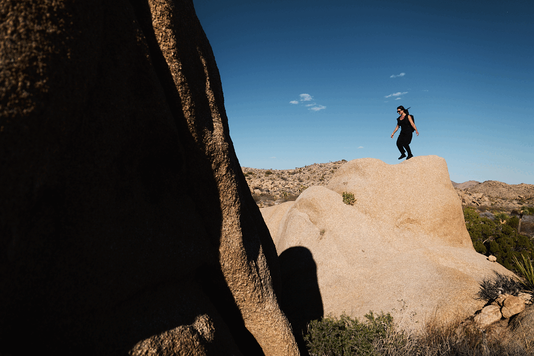 person skipping on rock in the desert
