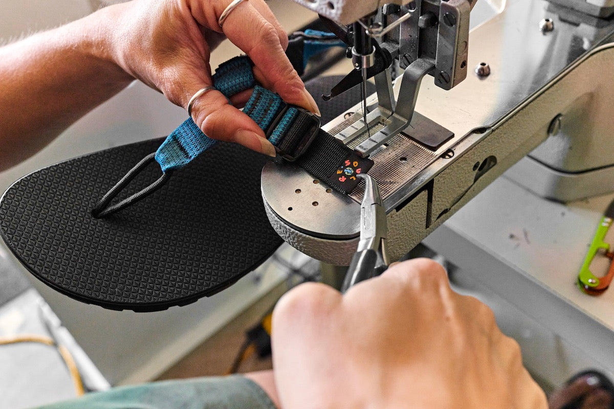 A Cairn sandal being re-sewn