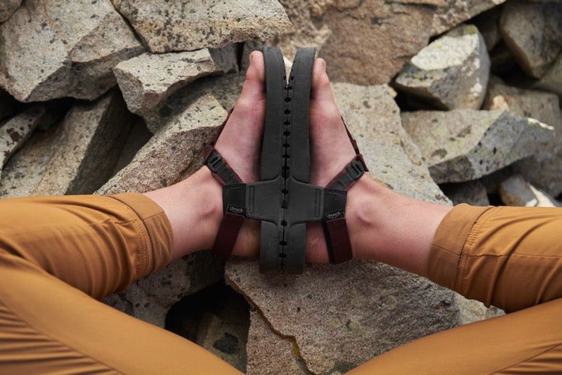 POV view of someone looking at their feet sitting down wearing cairn evo c sandals.