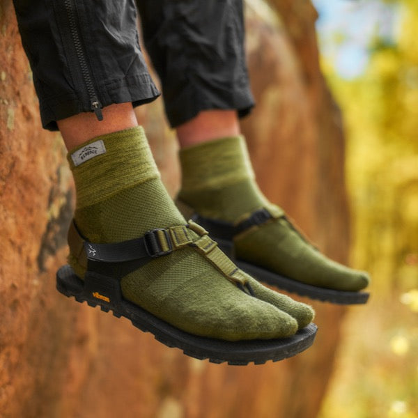 Closeup of someone wearing Bedrock split-toe socks and cairn sandals