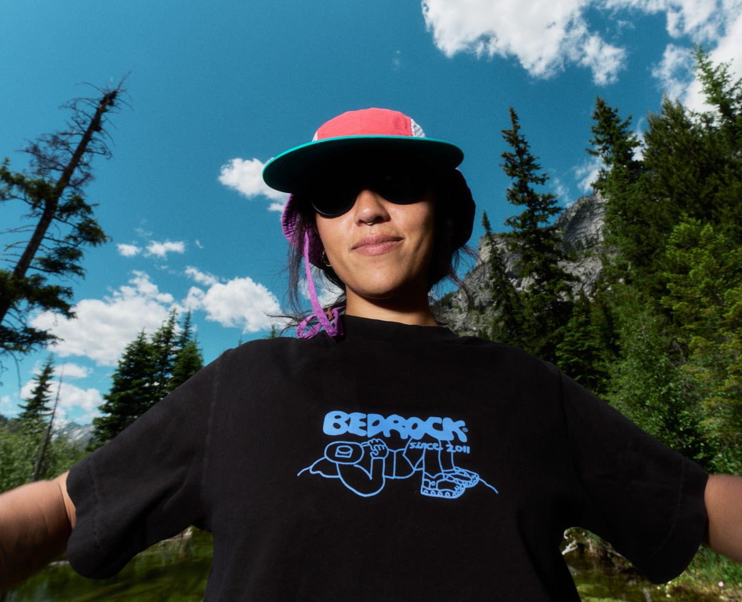 Person wearing Black t-shirt with Bedrock logo and Since 2011 written on it