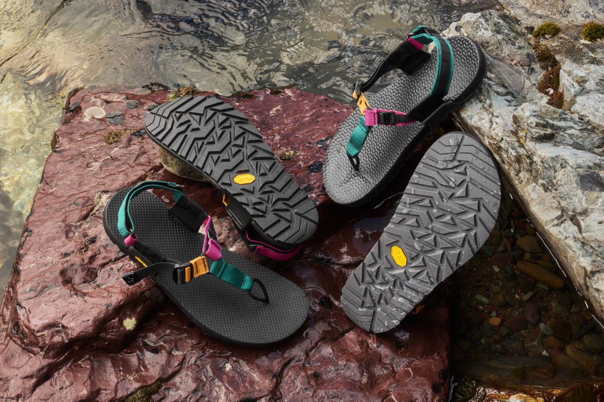 Cairn Evo and Cairn Evo 3D Pro Tourmaline sandals displayed on a wet red rock