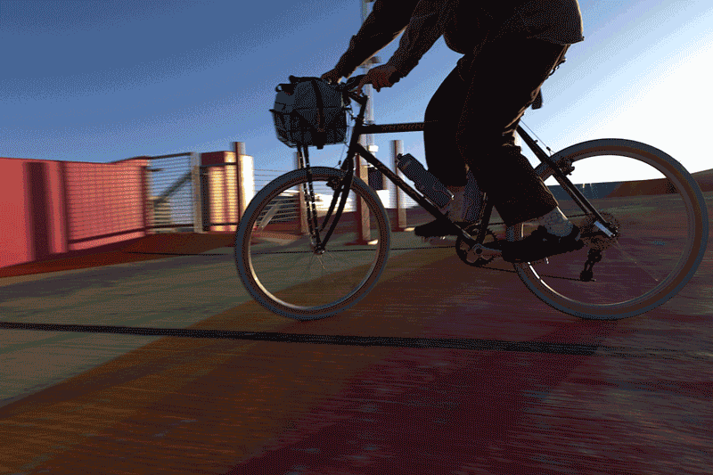 person riding bike wearing deep plum leather suede mountain clogs