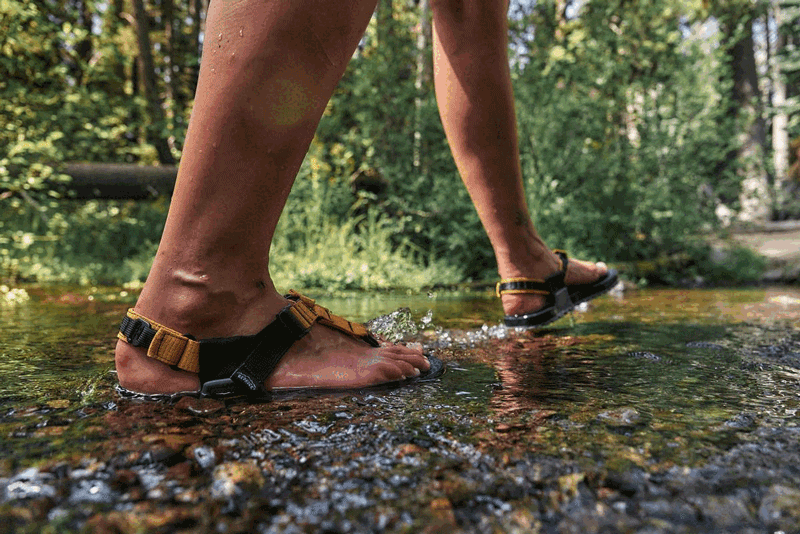 person walking though stream crossing on a trail in cairn eo 3d pro sandals