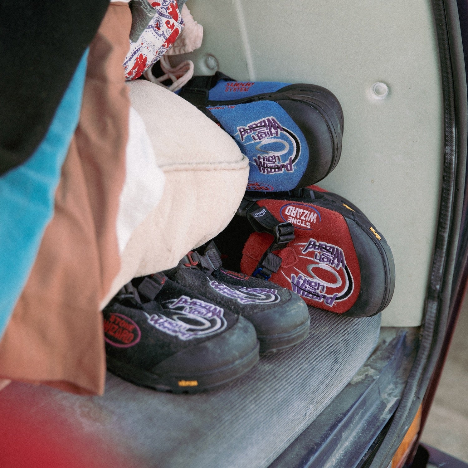 Stone Wizard Cyber Blue Clogs on a car seat