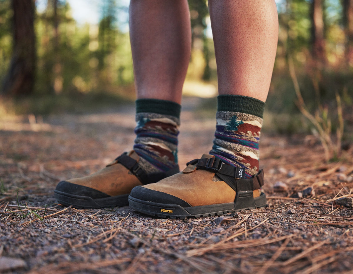 Person wearing a pair of Brown Nubuck Leather Mountain Clogs on hiking trail
